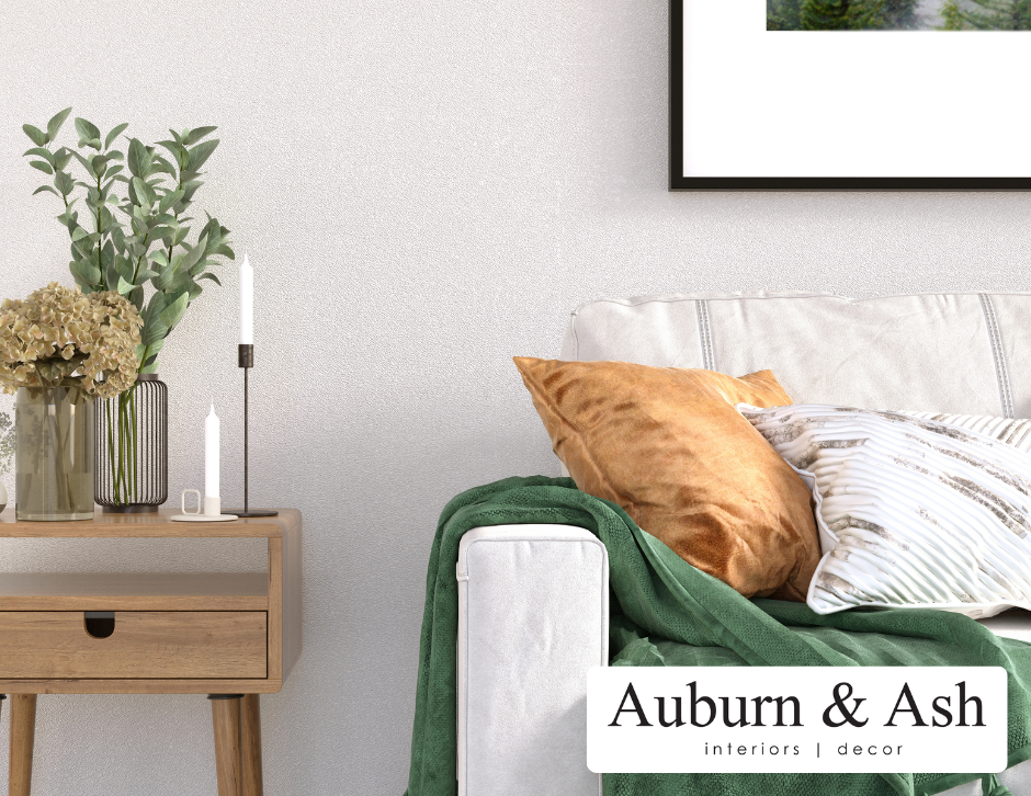A striking green throw over a white couch with gold accent pillow. Shop for luxury home decor in Red Deer at Auburn & Ash Design.